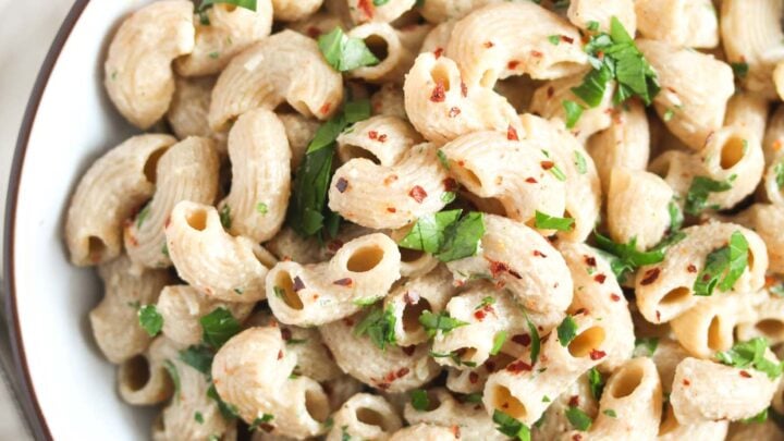 elbow macaroni coated with sauce in a bowl.