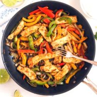 halloumi fajitas in a pan with a fork on top.
