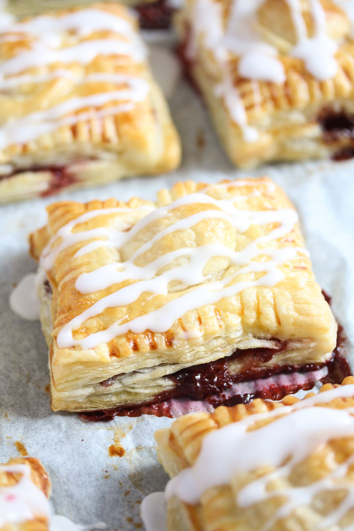one large strawberry turnover sprinkled with sugar icing.