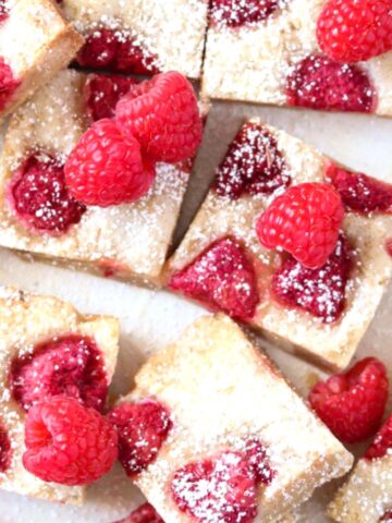 white chocolate and raspberry brownies topped with fresh berries.