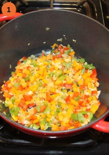 sauteing chopped vegetables for soup in a dutch oven.