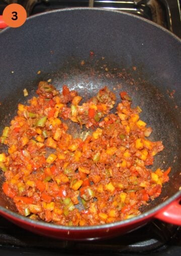 vegetables and tomato paste for soup mixed in a pot.