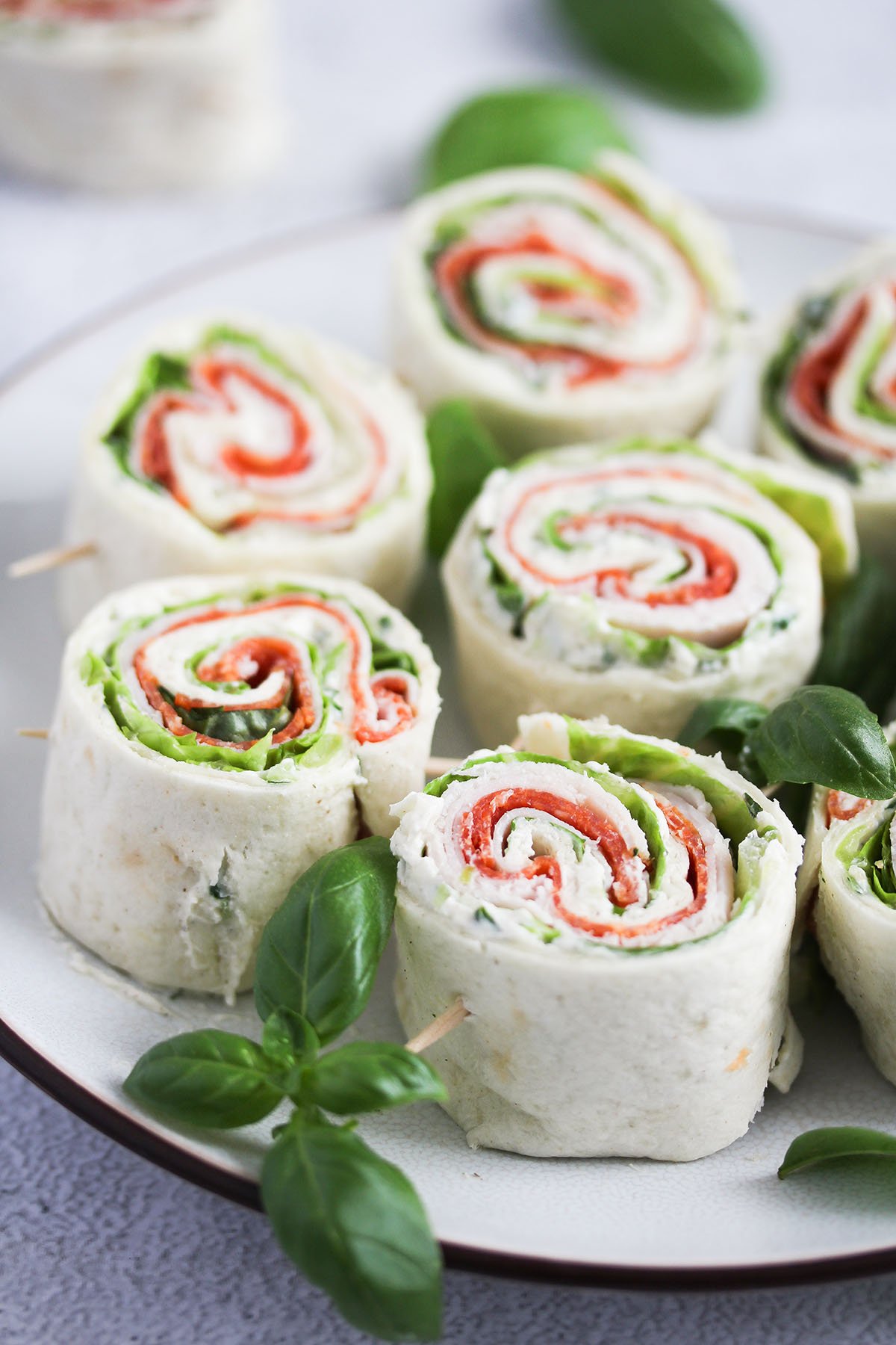sandwich pinwheels with salami, lettuce and cream cheese.