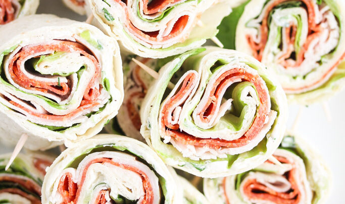 overhead view of lots of tortilla pinwheels showing the filling.