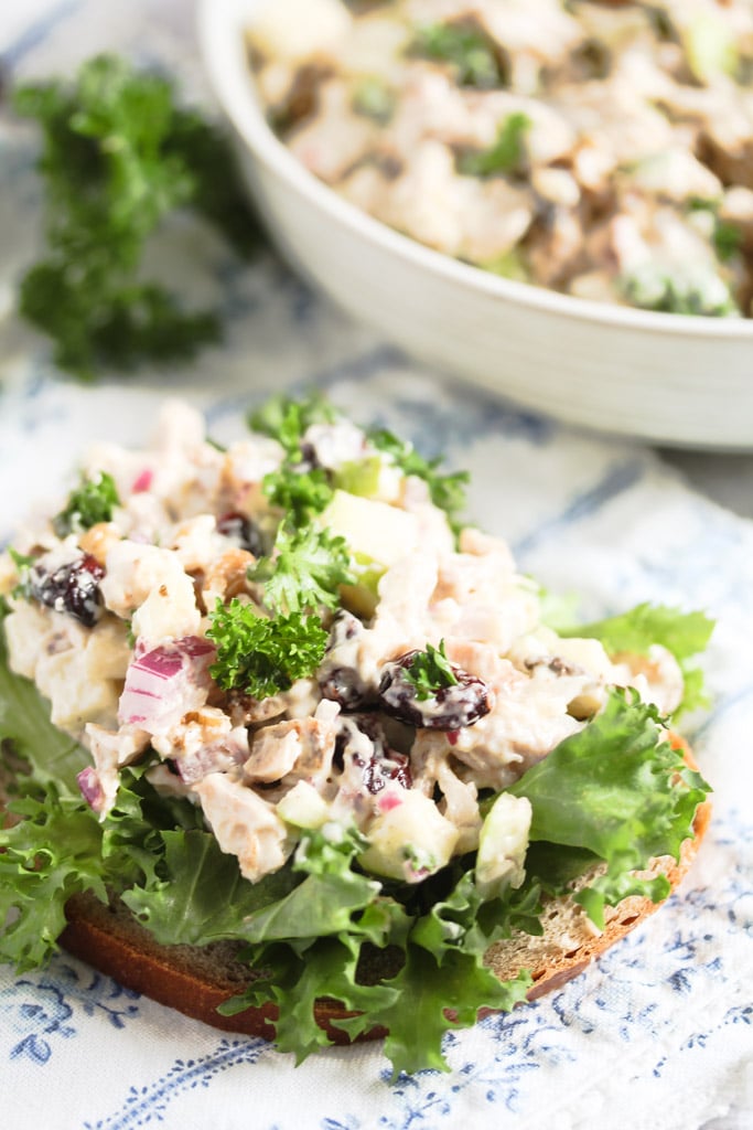 slice of bread with a lettuce leaf and lots of chicken salad on top.