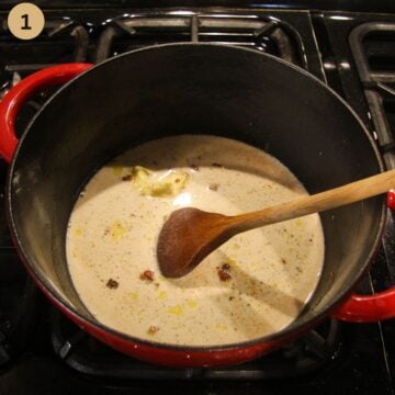 mixing the ingredients for making mac and cheese sauce without flour in a pot with a wooden spoon.