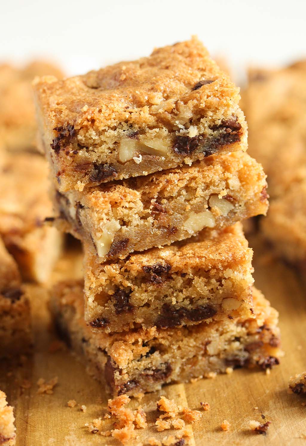 four blondies with chocolate chips stapled on a wooden board.