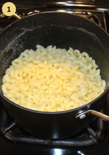 cooked macaroni in a large saucepan on the stovetop.