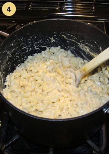 mixing macaroni with cheese with a wooden spoon in a saucepan.