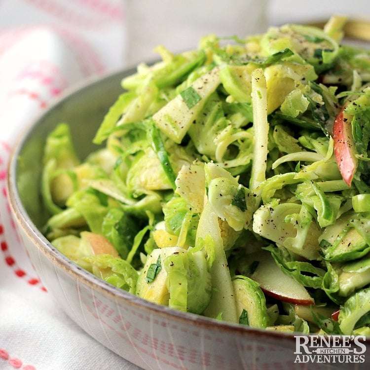 shaved brussels sprouts salad close up in a bowl.