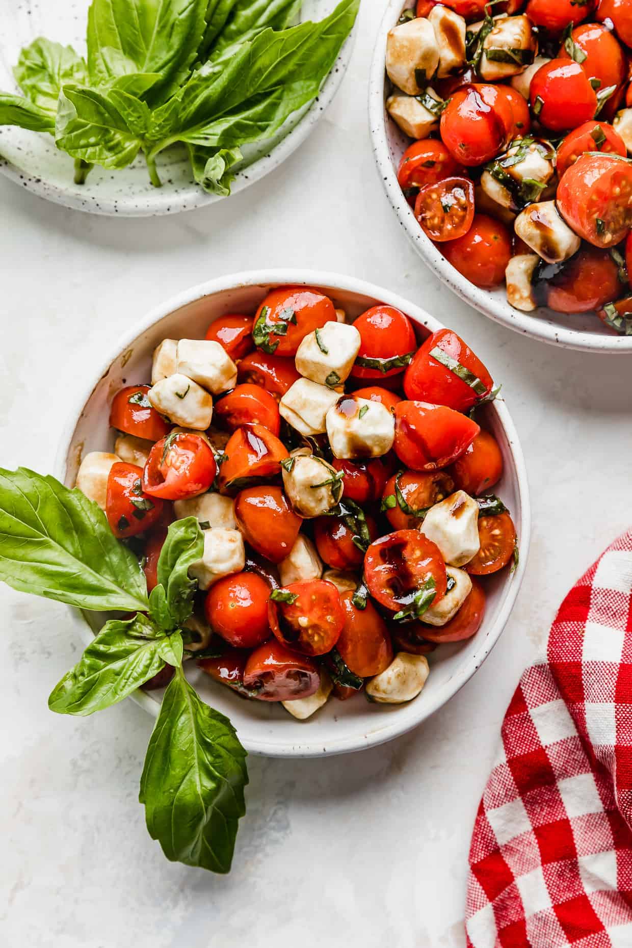 bowls of caprese salad with basil.