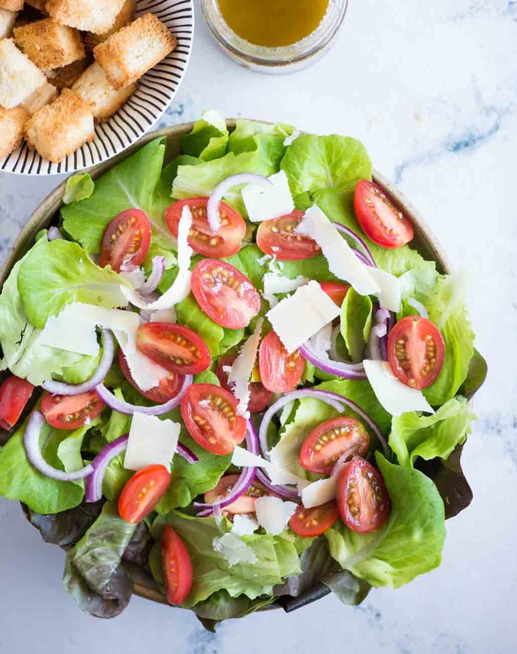 green salad with tomatoes and onions.