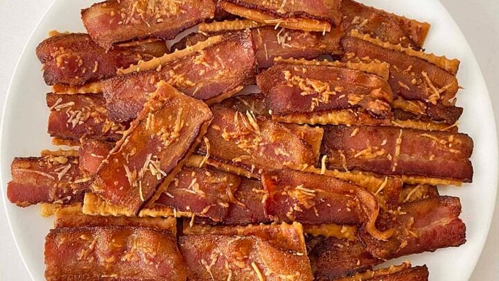 bacon parmesan crackers on a white plate close up.