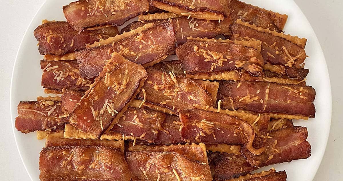 bacon parmesan crackers on a white plate close up.