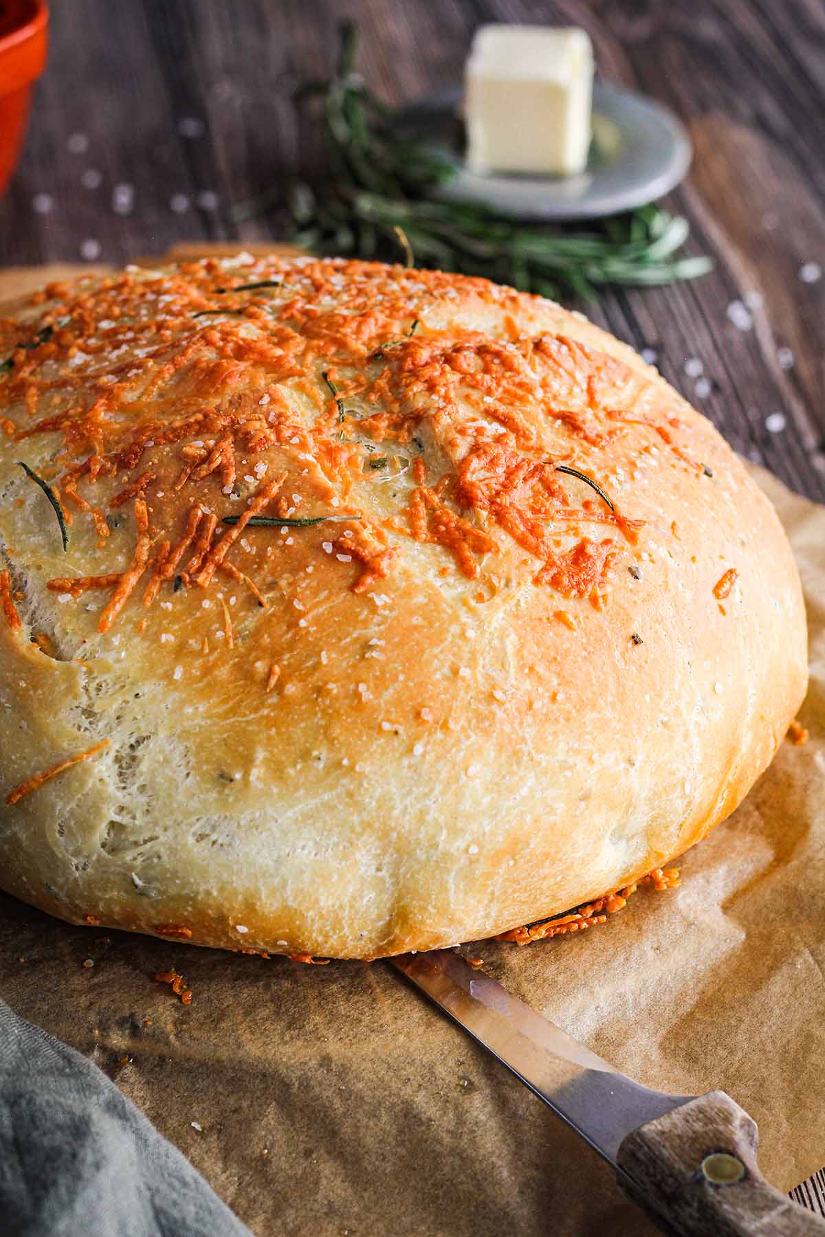 close up rosemary bread loaf on a rustic table.