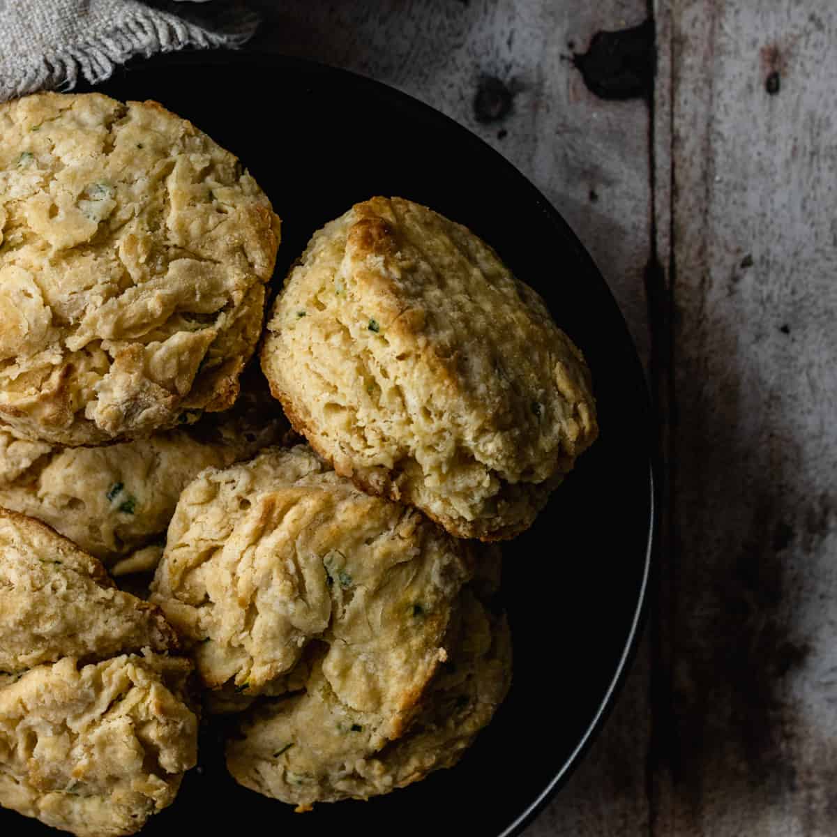 dark image of garlic butter biscuits in a black bowl..