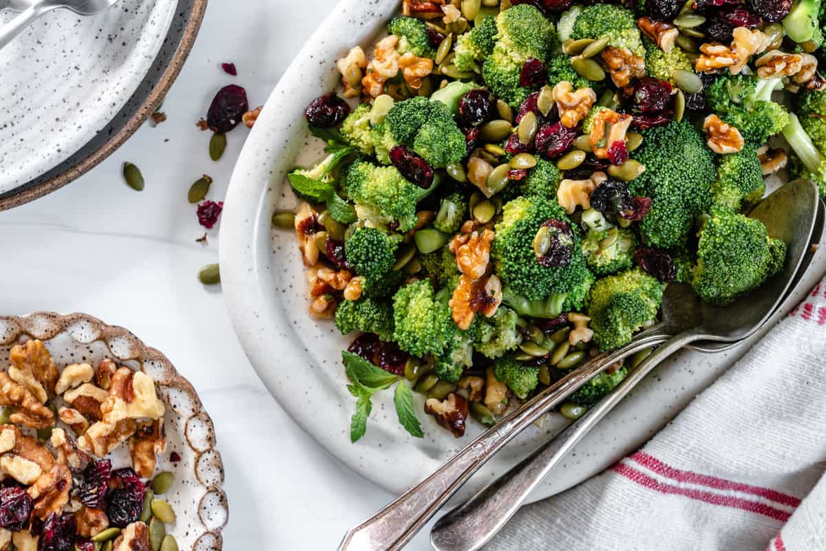 overhead view of a platter of salad with broccoli.