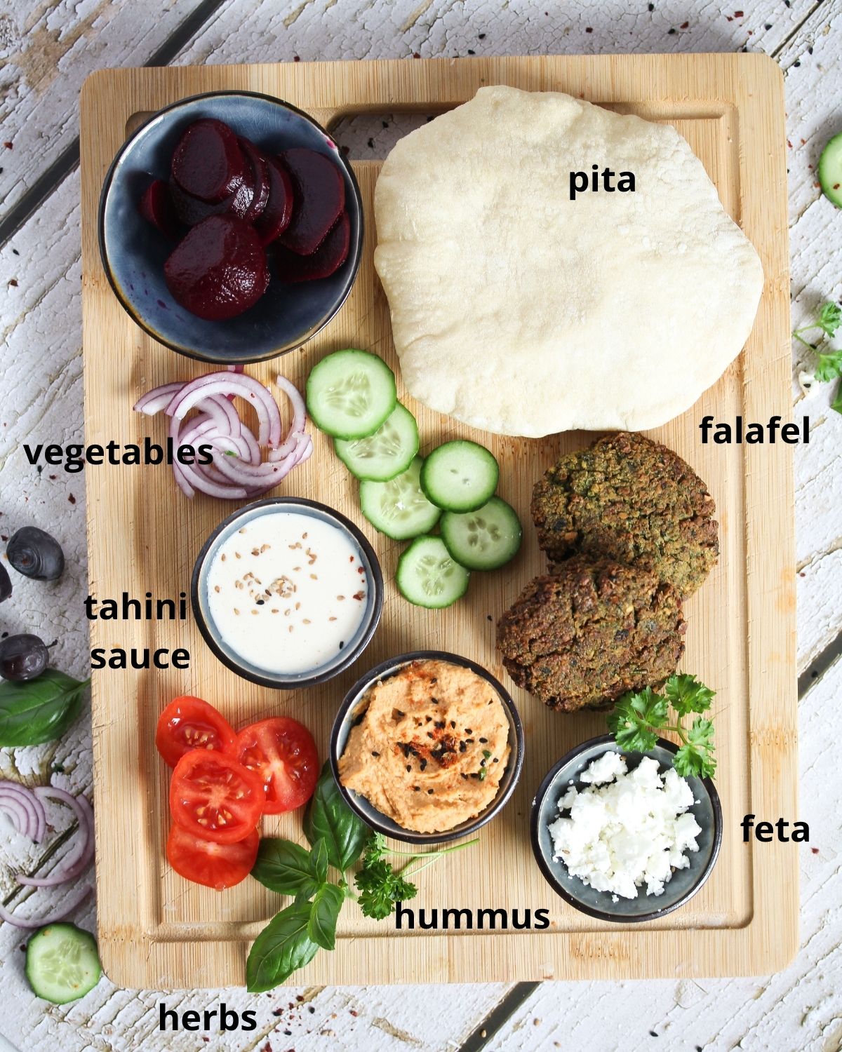 ingredients for falafel plate on a wooden board.