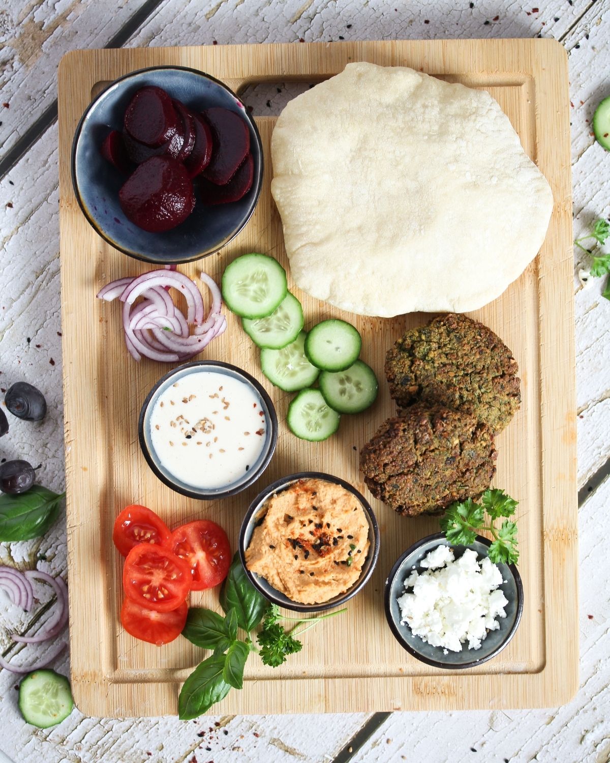 ingredients for making falafel sandwich on a wooden board overhead view.