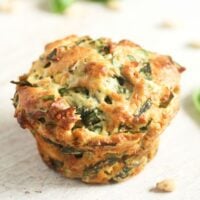 one golden spinach and feta muffin close up.