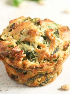one golden spinach and feta muffin close up.