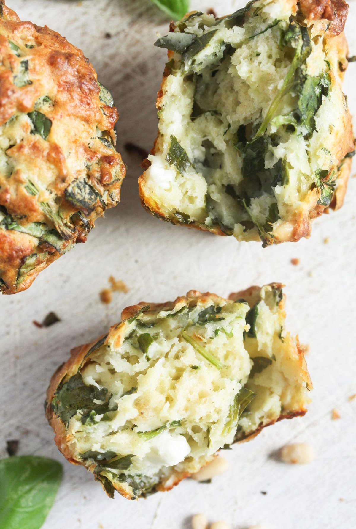 halved cheese muffin with spinach on the table.