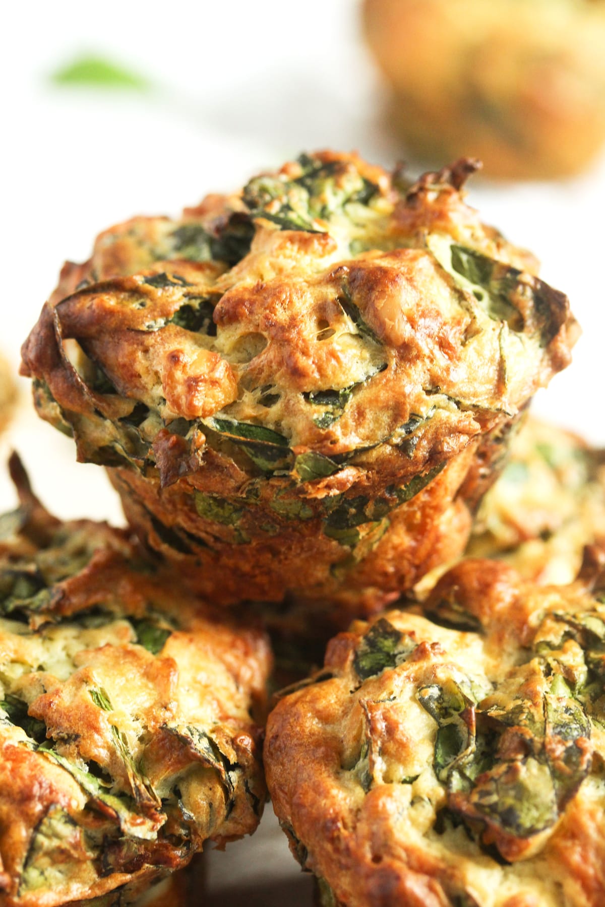 three stapled spinach muffins with feta and parmesan.
