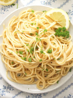small plate with lemon pepper pasta sprinkled with parsley.