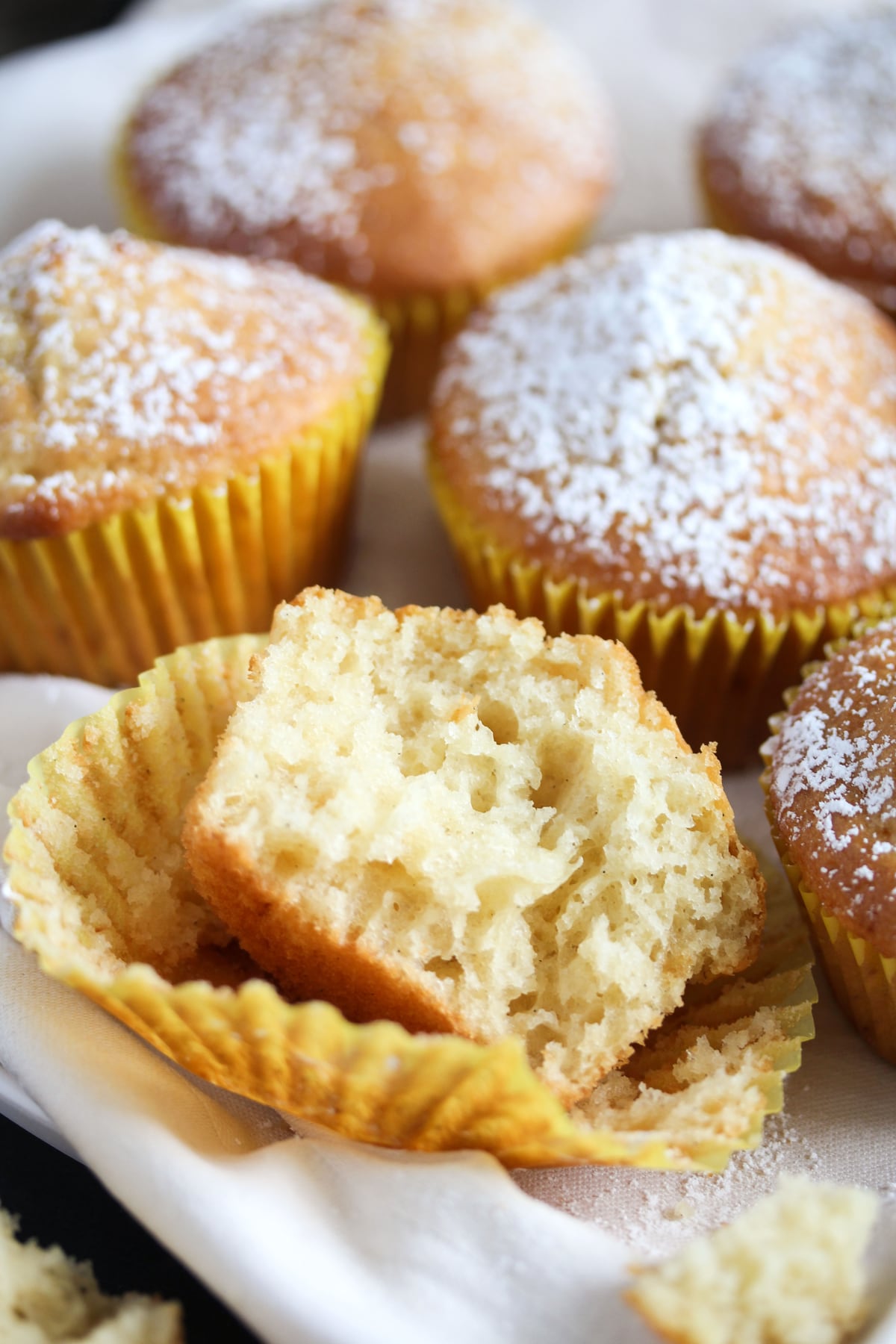 several muffins, one of them split to show the crumb.