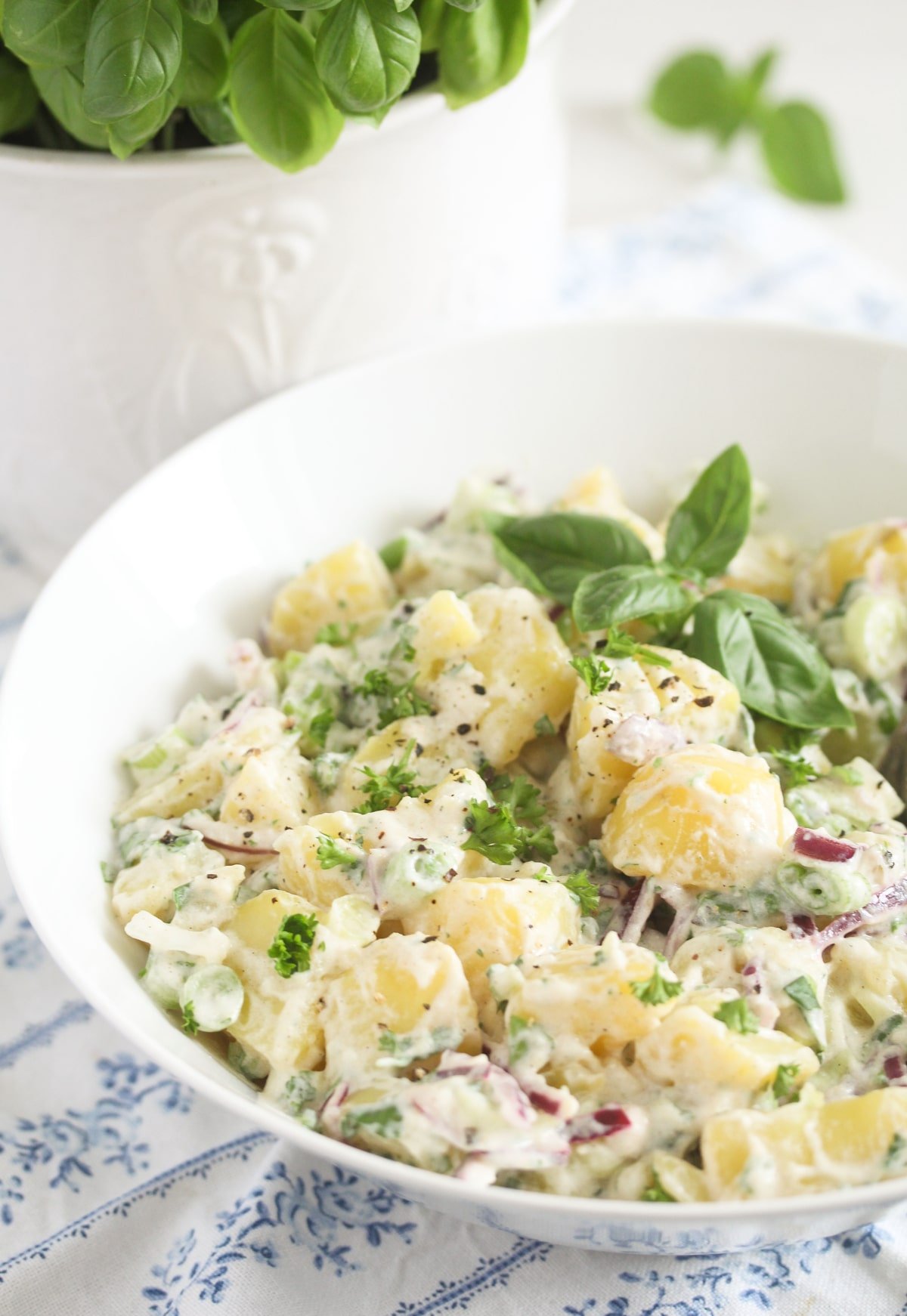 potato salad with onions and basil in a vintage bowl.