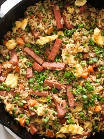 close up of spam fried rice with chopped parsley on top.