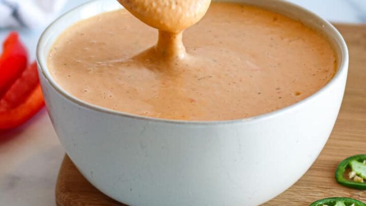 spoon lifting baja sauce from a small bowl.