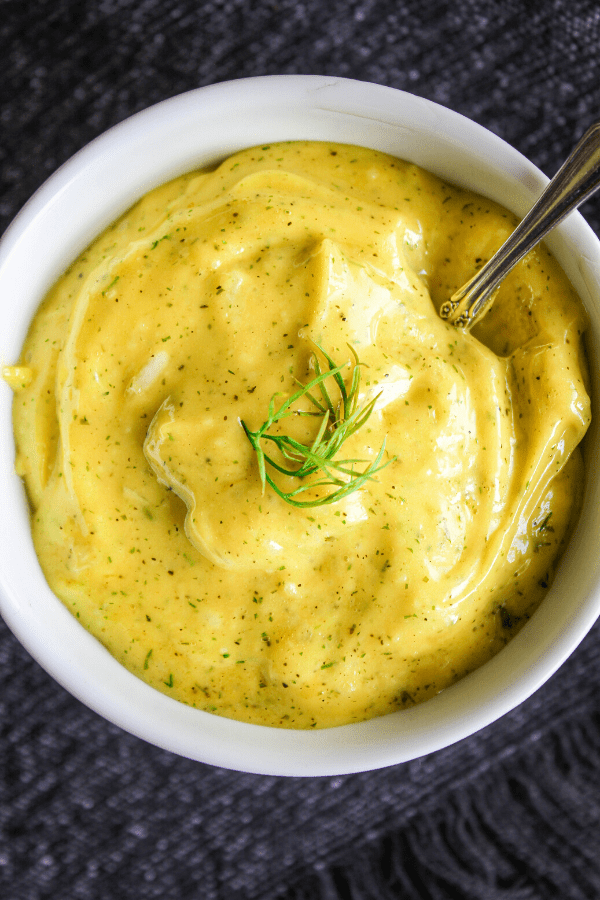 deeply yellow lemon dill aioli in a bowl.
