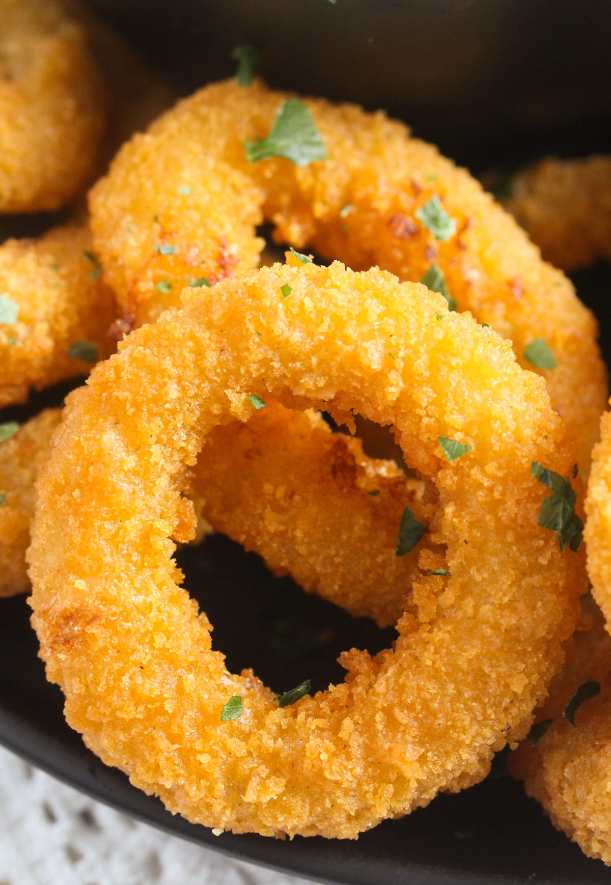 close up of a golden fried calamari ring.