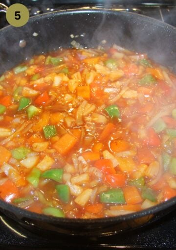 sweet and sour chicken sauce cooking in a pan.