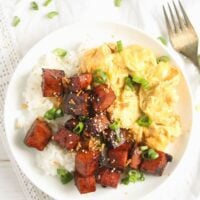 white plate with hawaiian spam breakfast with eggs and rice.