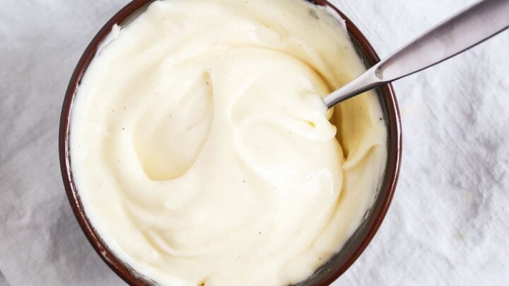 bowl of homemade mayonnaise with a spoon in it.