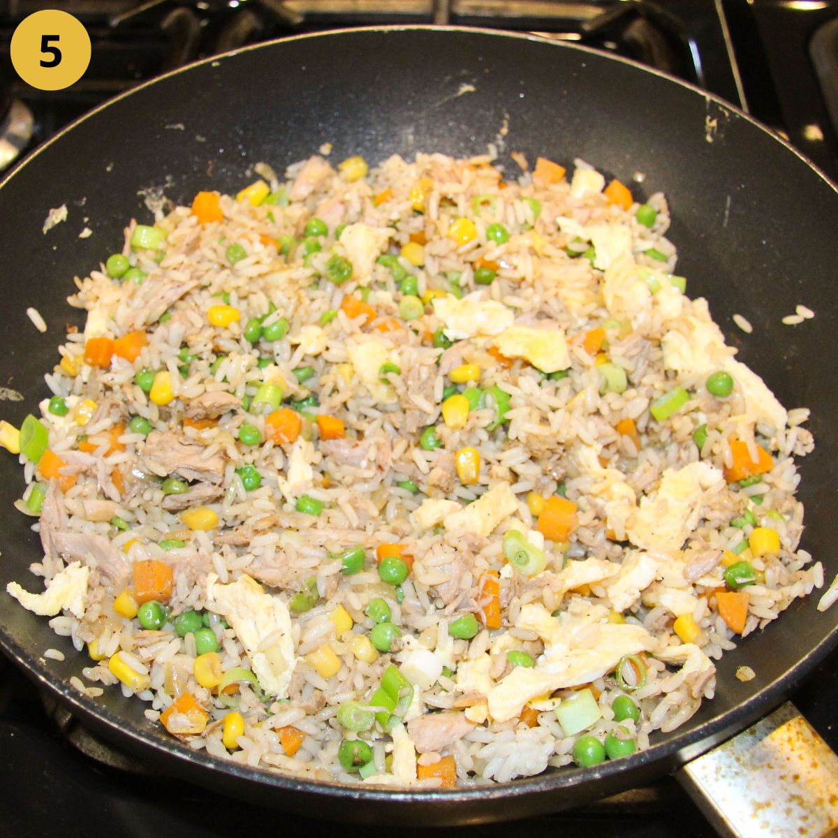 frying rice and vegetables in a large skillet.
