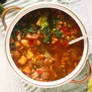 chicken and cabbage soup in a vintage bowl with a spoon in it.