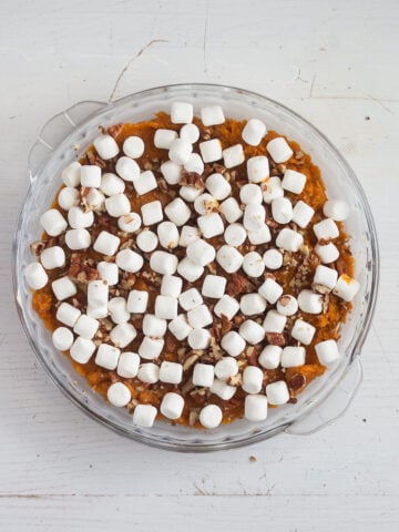 adding mini marshmallows to casserole.