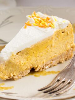 slice of philadelphia pumpkin cheesecake with a fork.