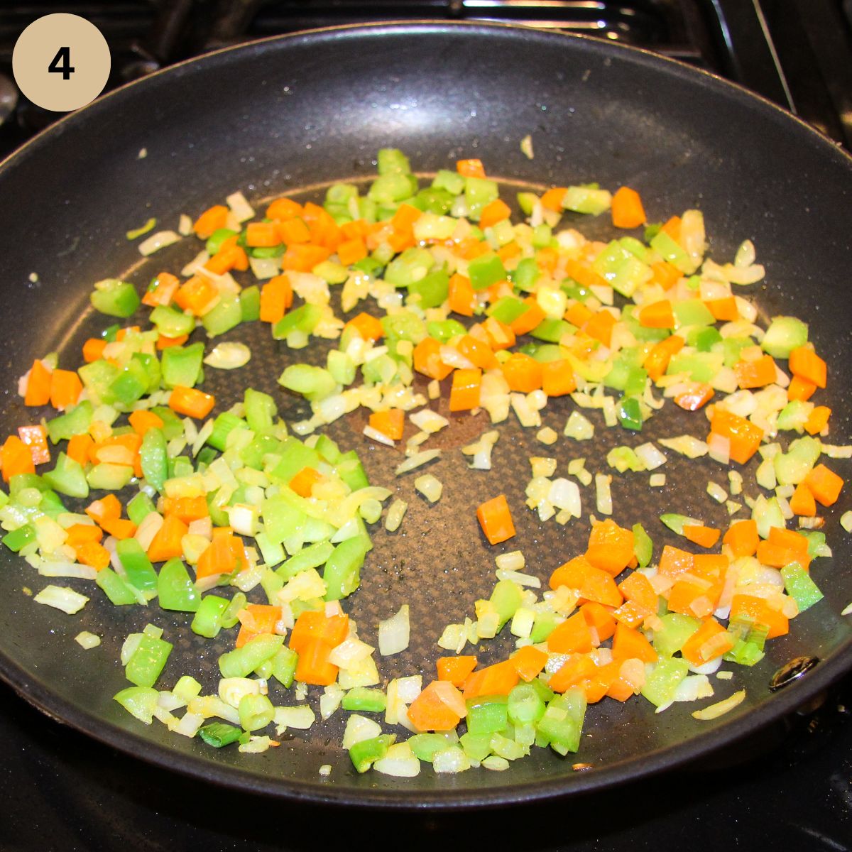 cooking diced carrots, peppers and onion in a large pan.