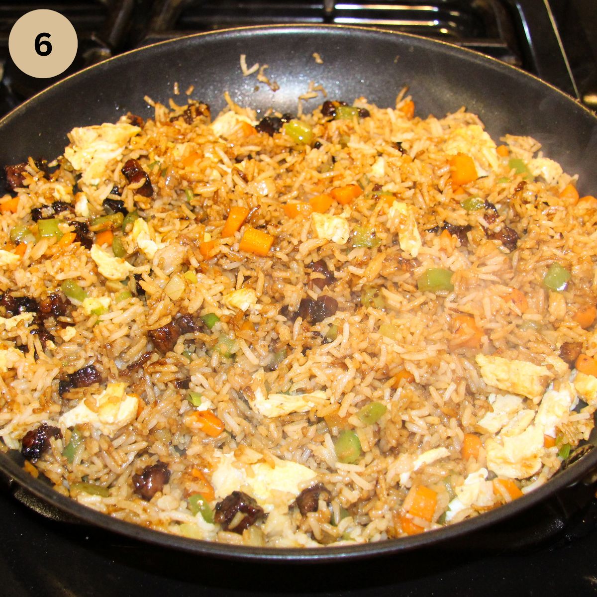 adding eggs and pork pieces to fried rice in the pan.