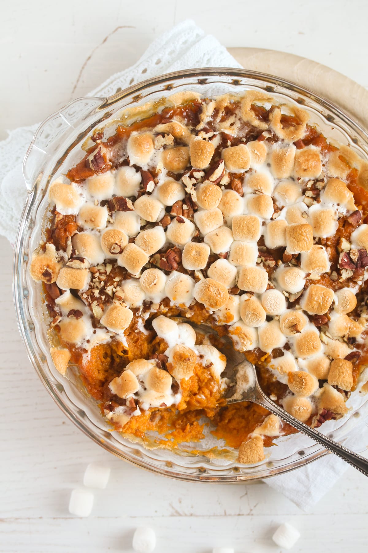 sweet potato dessert topped with marshmallows and with a spoon in it.