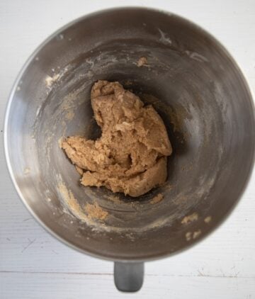 scraped batter for cookies in a large metalic bowl.