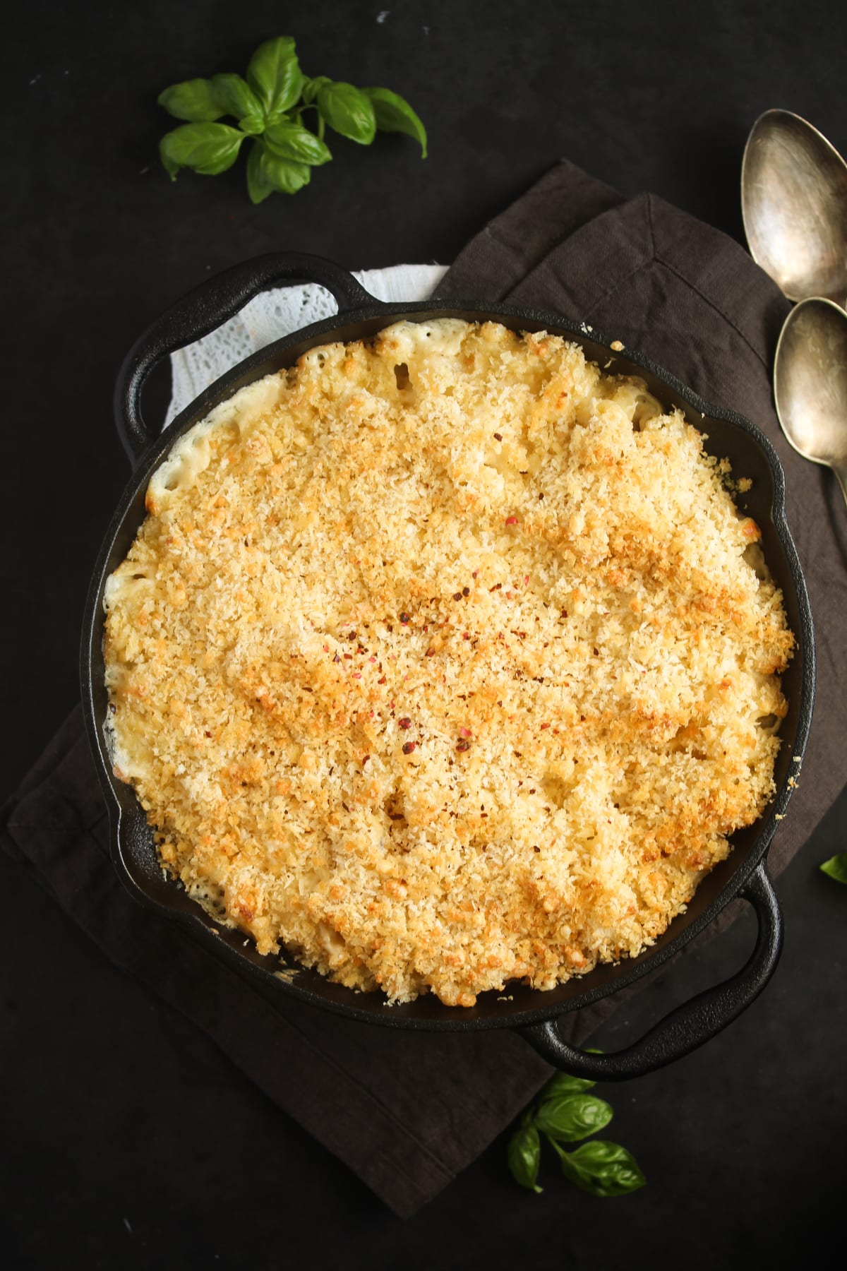 overhead view of a cast-iron skillet with baked mac and cheese topped with panko.