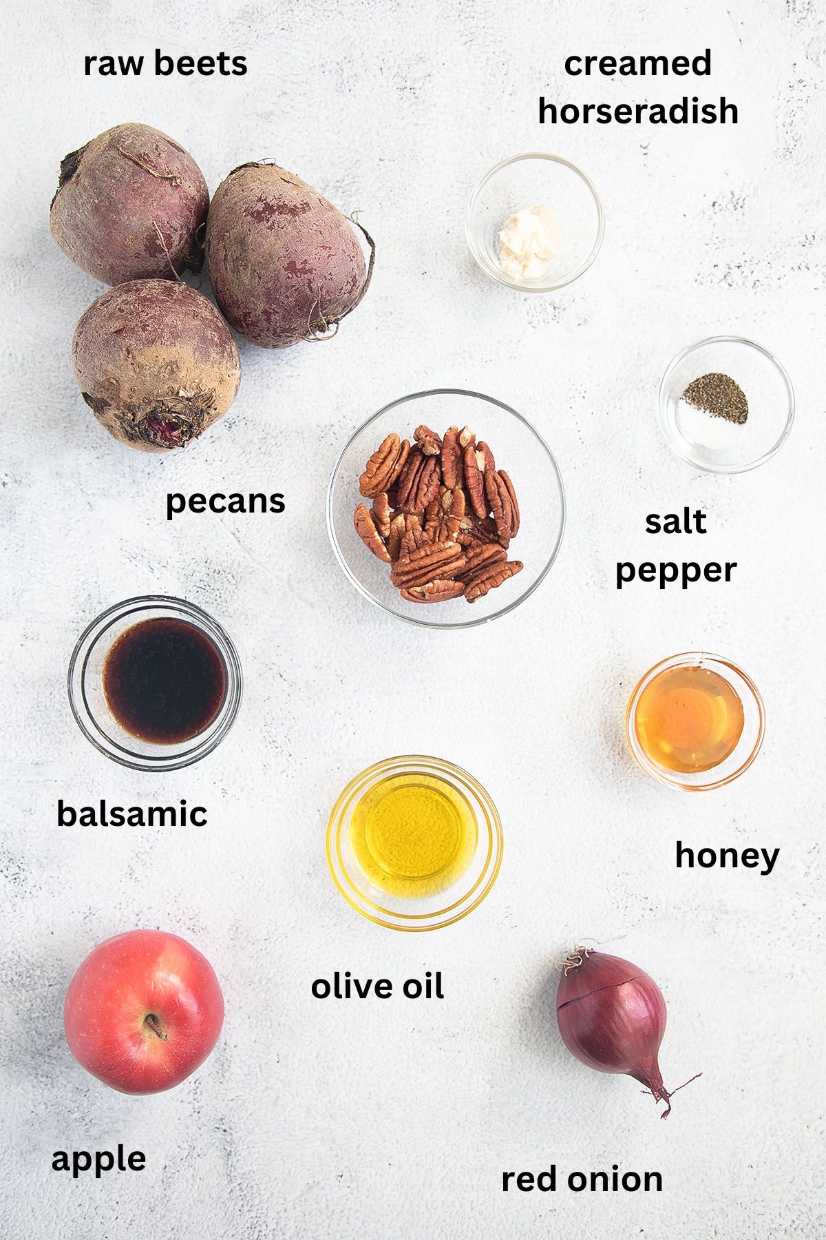 listed ingredients for making fresh salad with beetroot, apple, red onion, balsamic and pecans.