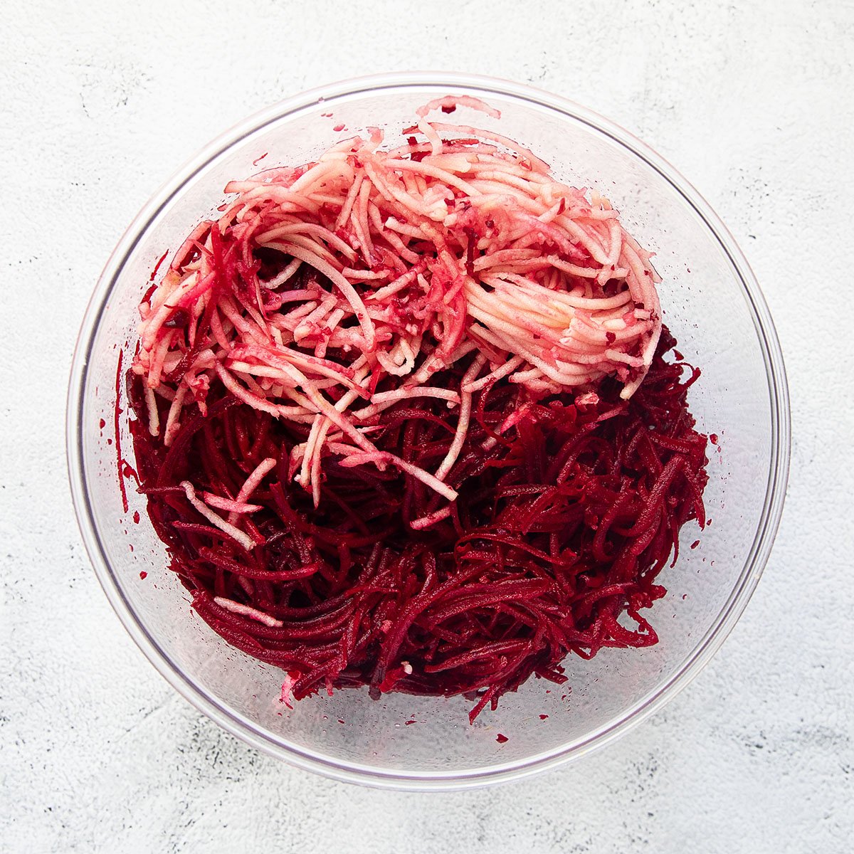 bowl with grated beetroot and apple.