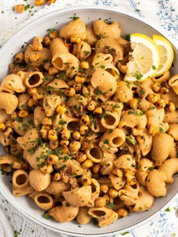 close up bowl of hummus pasta topped with crispy chickpeas.