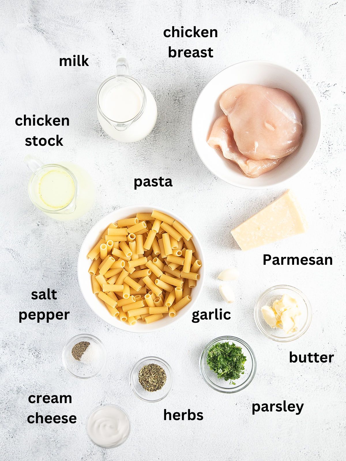 listed ingredients for cooking rigatoni with chicken breast, parmesan and garlic.